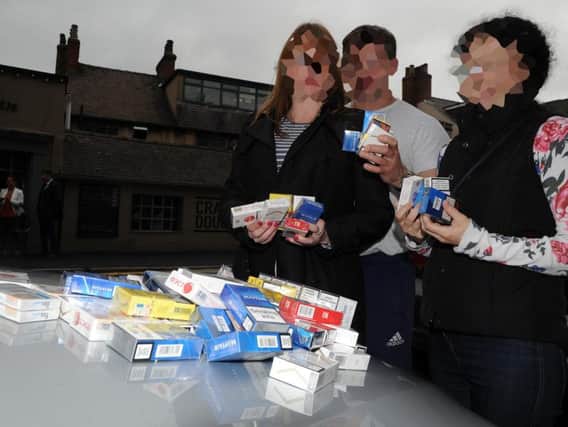 Investigators with a haul of illicit cigarettes after an operation in Sheffield