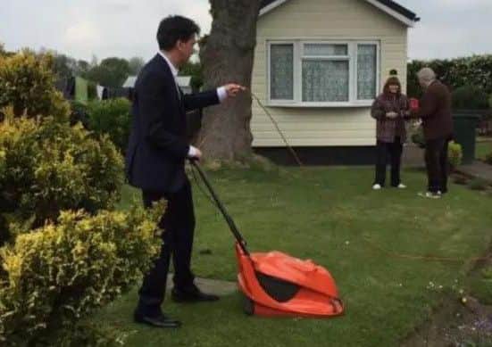 Ed Miliband was pictured cutting a voter's lawn.