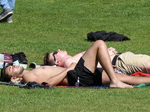 People enjoy the sun in Weston Park, Sheffield