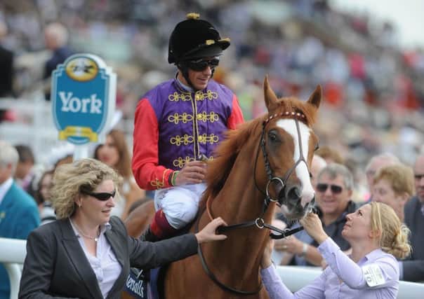 The royal colours of the Queen, sported here by Frankie Dettori, which could be carried to success at Ascot on the final day of the meeting by Dartmouth in the Hardwicke Stakes.