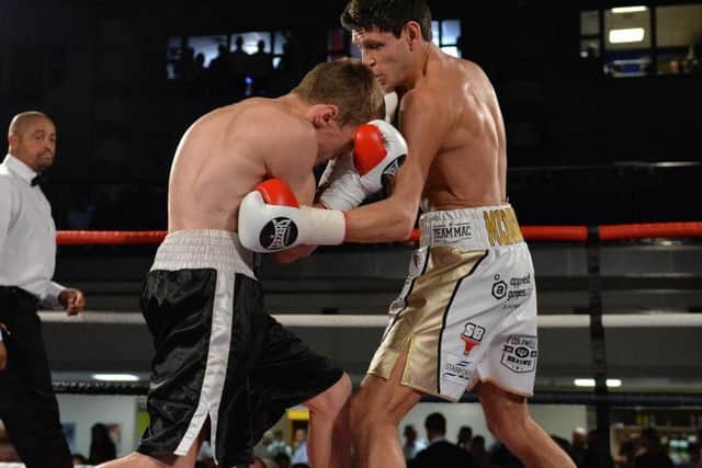 Gavin McDonnell sends in a hefty shot to the body of Simas Volosinas. Picture: Dean Woolley