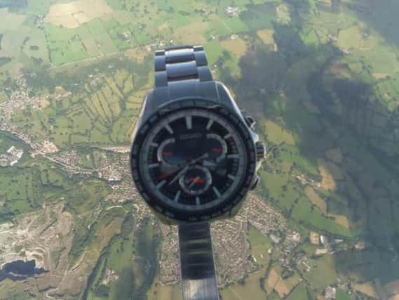 The watch floats high above Earth.