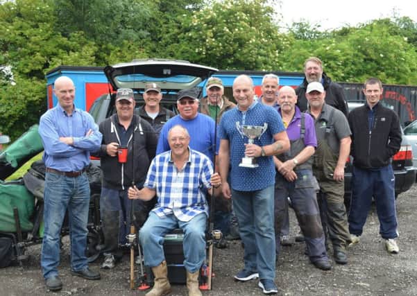 Anglers representing Phillips 66, who raised funds for Lindsey Lodge Hospice, are pictured with the John Parker Memorial Trophy before the match