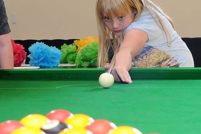 Keira Jones plays pool at the launch of Tickhill Youth Hub.