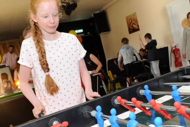 Inaya Stubbs plays table footballl at the launch of Tickhill Youth Hub.