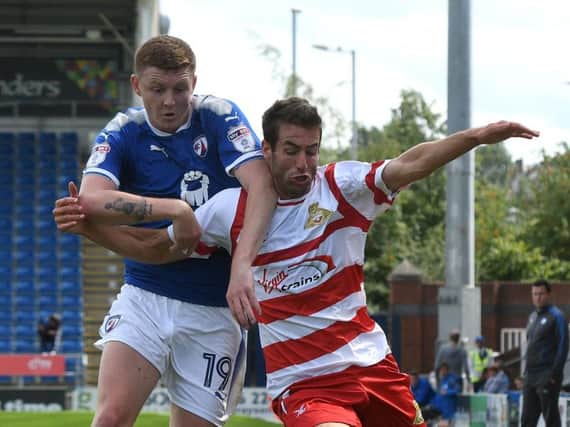 Matty Blair tussles with Chesterfield's Dion Donohue. Picture: Andy Roe