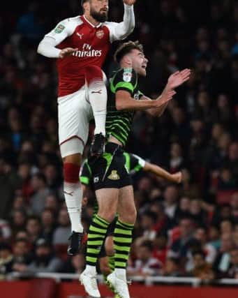 Doncaster's Ben Whiteman battles with Arsenal's Oliver Giroud