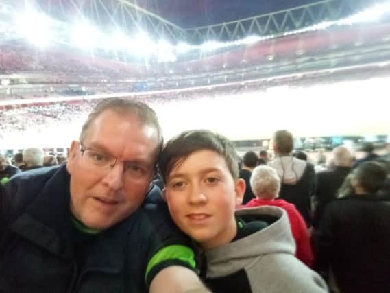 Free Press reporter Darren Burke and his son at Arsenal's Emirates Stadium.