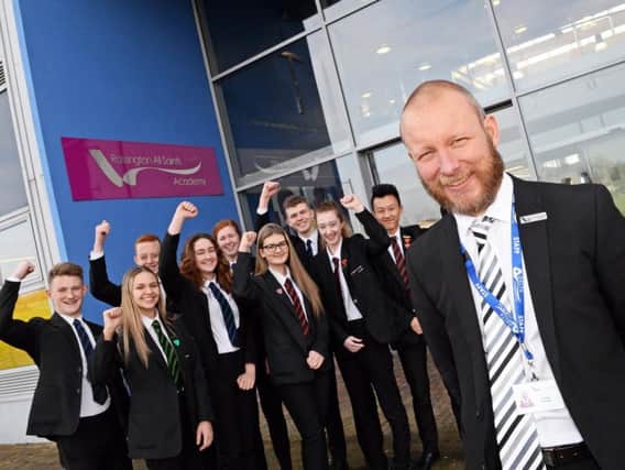 Principal Jamie Lawler celebrates with pupils after Rossington All Saints Academy, topped the Progress 8 table in Doncaster. Picture: Marie Caley NDFP All Saints MC 2