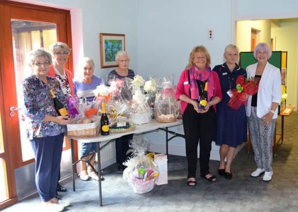 Members of the Lindsey Lodge Messingham Supporters Group are pictured with Hospice staff with some of the raffle prizes donated to the Ladies Pamper Evening