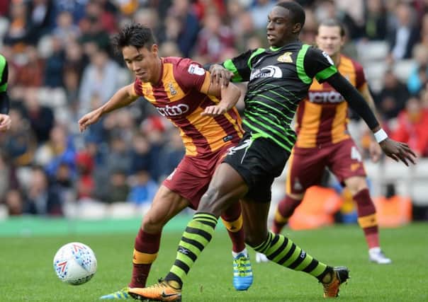 Rovers' star man Rodney Kongolo challenges Bradford's Adam Chicksen. Picture Bruce Rollinson