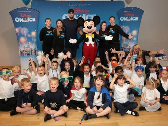 Lucky children with Ashley Banjo get a visit from Mickey Mouse during a Disney On Ice Fit To Dance workshop