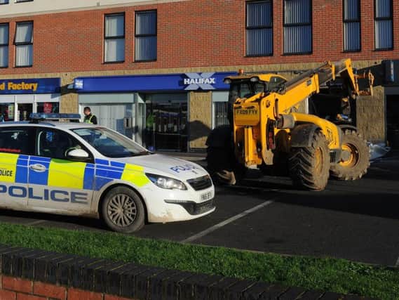 Police officers outside the Halifax bank in Armthorpe, following a raid this morning
