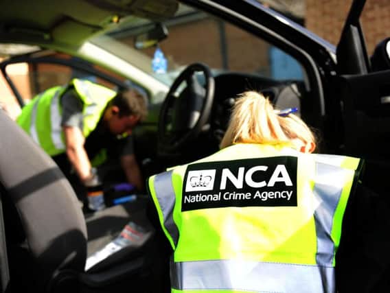 The National Crime Agency searching a car at a previous crackdown carried out alongside  South Yorkshire Police at HMP Lindholme