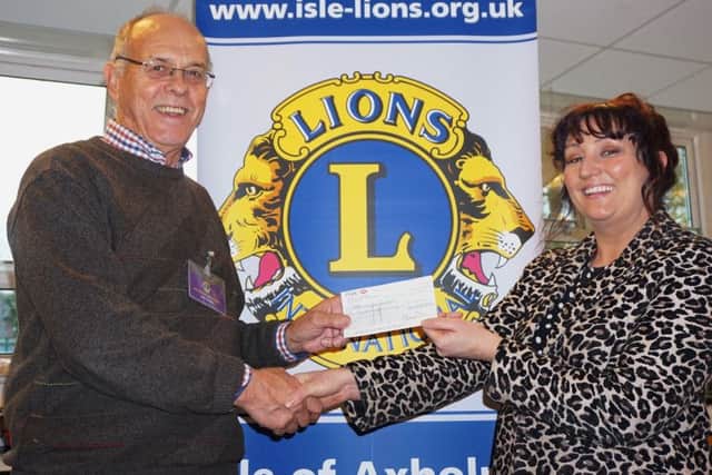 John Smedley present Axholme Academys head of creative arts Hayley Childs with Â£100