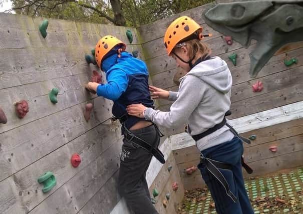 Children in Doncaster are benefitting from the Short Breaks scheme which allows them to take part in a number of school holiday activities and events. Doncaster Culture and Leisure Trust work with Doncaster Council to provide opportunities for children with disabilities and their families. A child is pictured here trying rock climbing.
