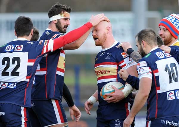 Jason Hill is congratulated on scoring one of Knights' tries.  Picture Scott Merrylees