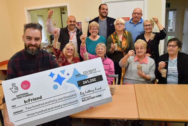 Group members pose with their cheque as they make fat ball bird feeders at the Ragusa Drive Communal Hall in Doncaster. Photo : Anthony Devlin