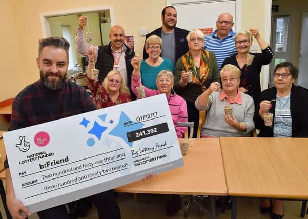 Group members pose with their cheque as they make fat ball bird feeders at the Ragusa Drive Communal Hall in Doncaster. Photo : Anthony Devlin
