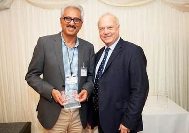 Professor Vora receives his award from charity chairman, Simon Dyson, at the House of Commons. Picture: Paul Meyler