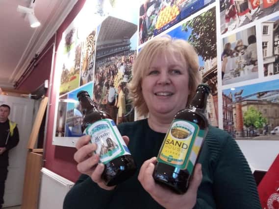 Katy Lewin, from Doncaster Tourist Information, with beer from Doncaster Brewery
