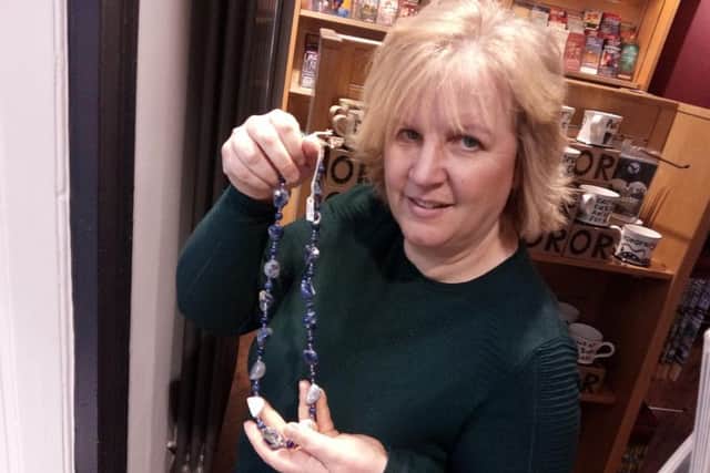 Katy Lewin, from Doncaster Tourist Information, with an item of Anne Robertson jewellery