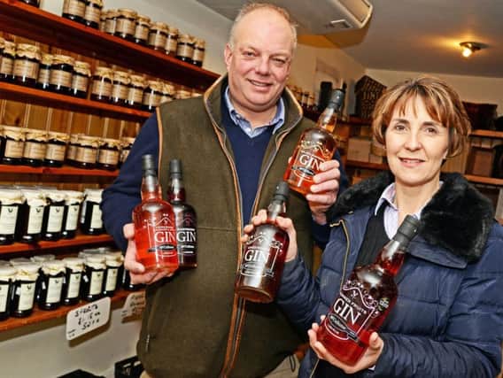 David McCallum and his wife Fiona, pictured with a selection of the fruit Gins they produce. Picture: Marie Caley NDFP McCallum Gin MC 1