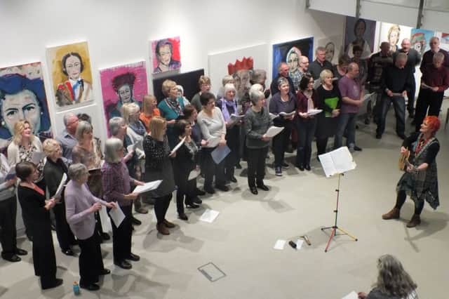 Janet Wood leads a Quirky Choir performance in the gallery at The Point