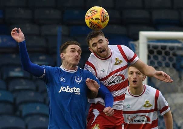 Andy Boyle tussles with Portsmouth's Oliver Hawkins on his debut for Rovers