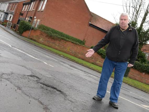 Mick Glynn, pictured by a Pot Hole on Hatfield High Street. Picture: Marie Caley Pot Holes MC 3