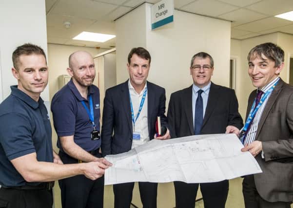Graham Royle looks over the plans for the new MRI scanner at Sheffield Children's Hospital with Chris Heafeyand Mark Haines from the radiology department, Chief executive John Somers and charity director David Vernon-Edwards
