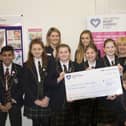 Toby Johns (front) and his parents (right) were delighted to present a cheque to CHSF representative Holly Rawlings (back left) along with Hill House School pupils