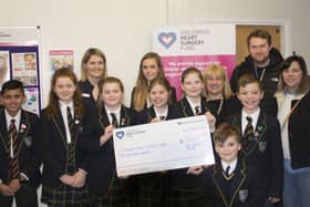 Toby Johns (front) and his parents (right) were delighted to present a cheque to CHSF representative Holly Rawlings (back left) along with Hill House School pupils