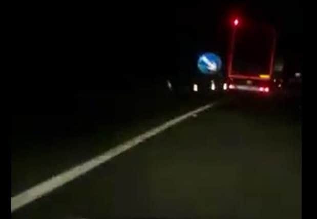 The lorry narrowly misses a temporary road sign on the A1.