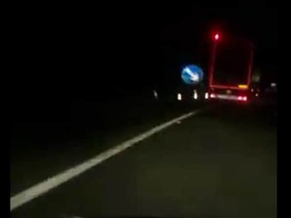 The lorry narrowly misses a temporary road sign on the A1.