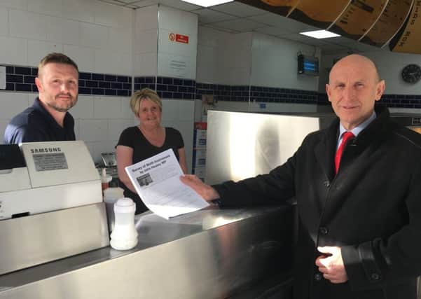 John Healey MP delivering a survey to a high street chippie in Wath