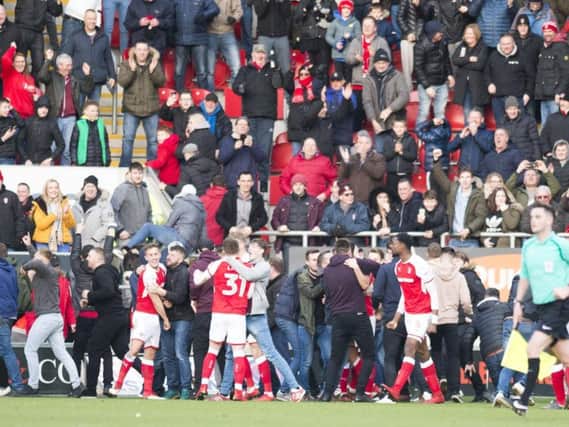 Rotherham players are swamped by fans after securing victory. Picture: Dean Atkins.