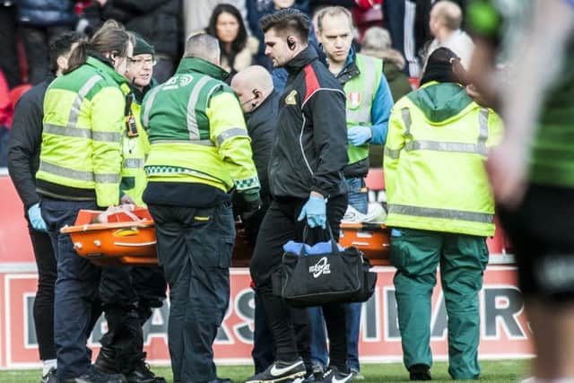 Tom Anderson is stretchered off.