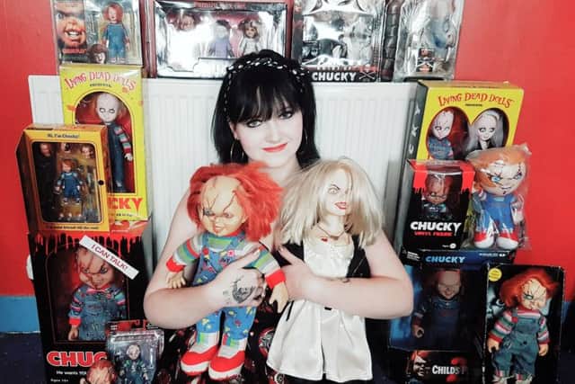 Becky with her collection of Chucky dolls.