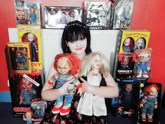 Becky with her collection of Chucky dolls.
