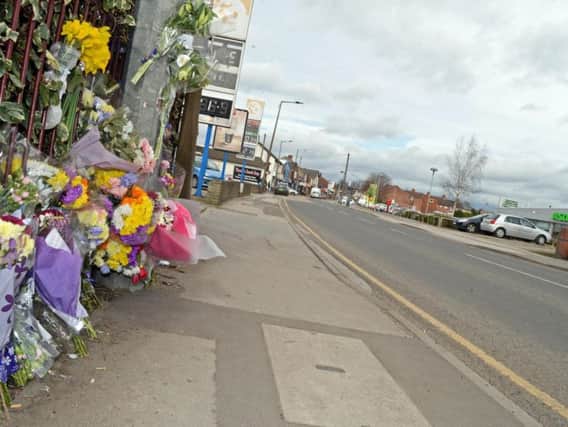 Floral tributes left at the scene of the collision.