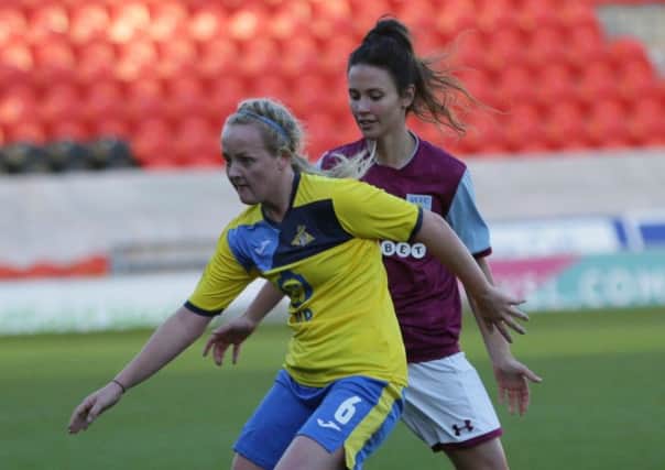 Chloe Peplow (yellow) in action for Doncaster Rovers Belles vs Aston Villa. Photo: Julian Barker