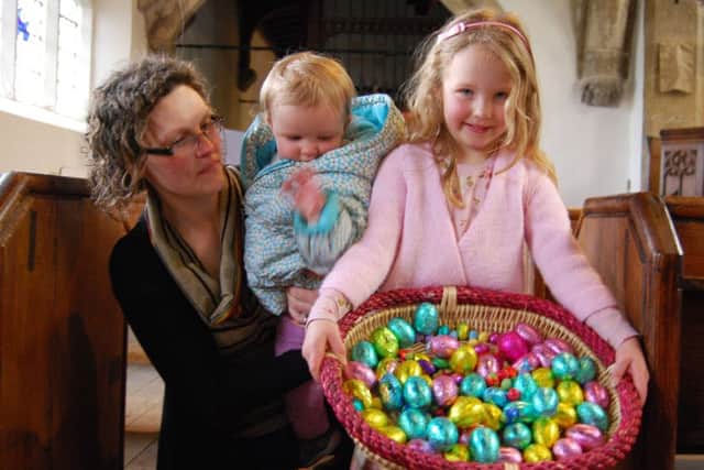 An Easter-themed coffee morning with hot cross buns and a childrens Easter egg hunt in All Saints Church raised Â£230 for Church funds. Pictured is Rachel Bowes with children Erin (centre) and Emily and some of the Easter eggs to be won.