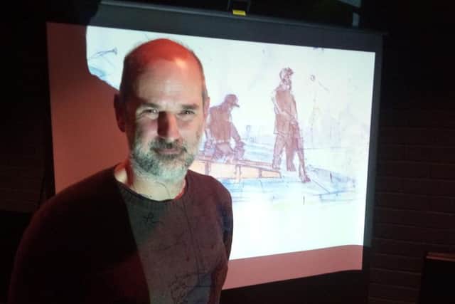 Sculptor Laurence Edwards has been commissioned to create a public art monument to Doncaster's miners. His original  draft design, which he has now decided against,  is pictured behind him