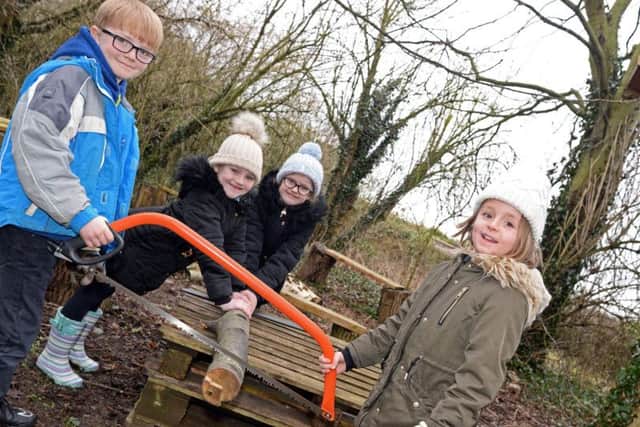 Reuban, Harriet, Evie and Aphia, pictured working in the Forest School.