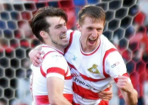 Tom Anderson celebrates scoring against Fleetwood with John Marquis.