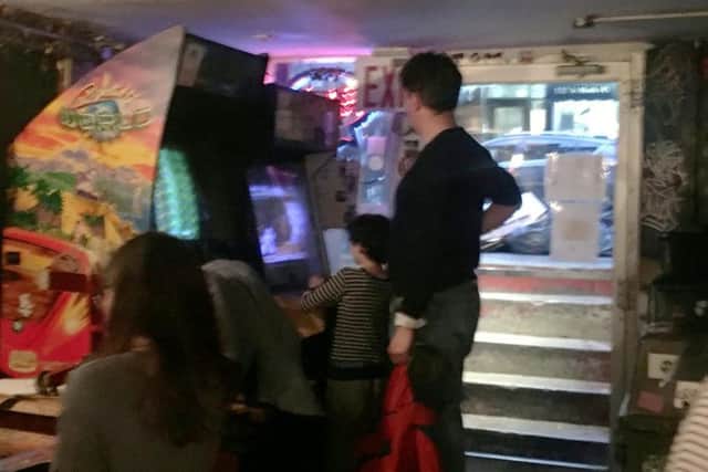 He was spotted near the arcade machines at Crif Dogs while his children played. (Photo: SWNS).