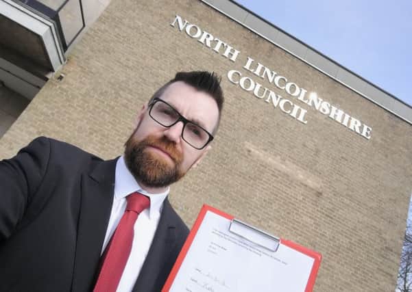 Campaigning councillor Paul McCartan outside North Lincolnshire Council offices urging council to fix potholes