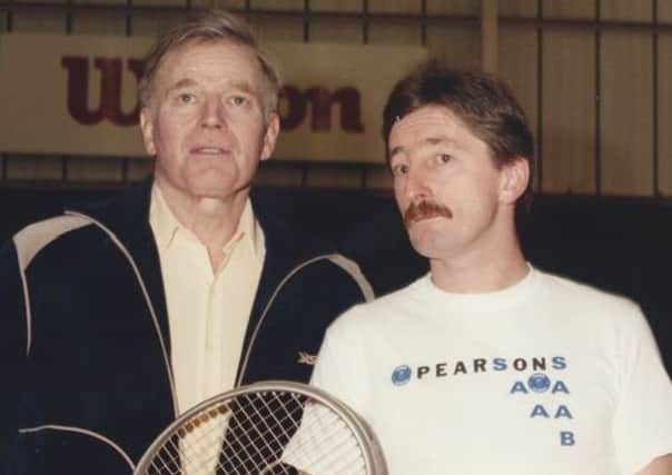 Actor Charlton Heston with tennis coach John Willis