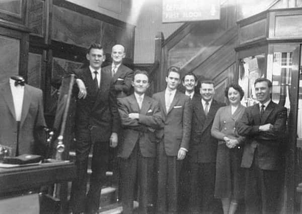 A photo taken inside the John Collier tailors shop on St Sepulchregate, Doncaster. The Manager  Mr Jack Harrod and his entire staff taken sometime during the late 50s early 60s. I am on this photo in the centre at the back and was at the shop maybe 2 years.

I just thought some of your readers may be interested is seeing this, no doubt many will remember shopping there.
